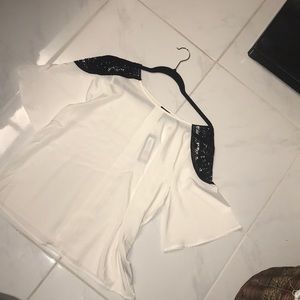 White blouse with black cut out shoulder detail